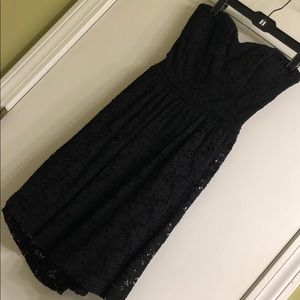 Strapless black crochet mini dress with back bow